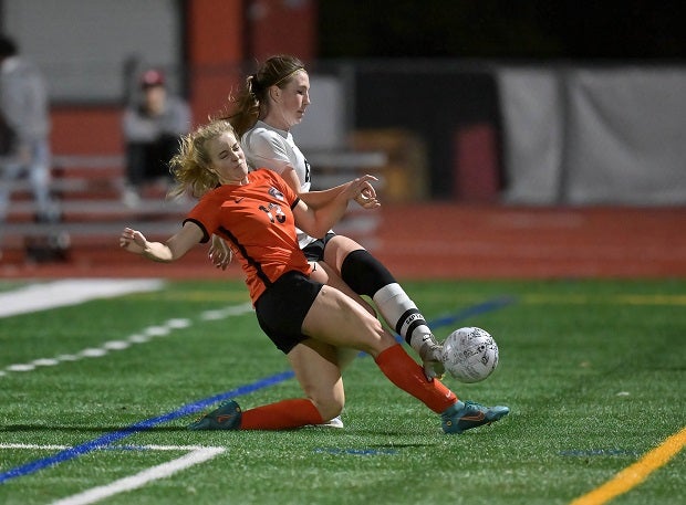 Leah Sulzberg of California (in orange) makes a slide tackle on Brittany Hahn of Granada in a close match as California took the 1-0 victory. (Photo: Jason Weed)