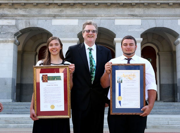 CIF/Farmers Athletes of the Year Amanda Kirkeby (left) and Cole Moody (right) pose with CIF Executive Director Roger Blake at the State Capitol on Thursday.  