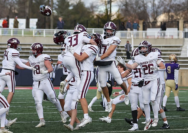 Garden City celebrates after beating Sayville 31-28 in last year's Long Island Division III championship game in New York. The Trojans own the nation's second-longest win streak at 54 games. (PHOTO: Ray Passaro)