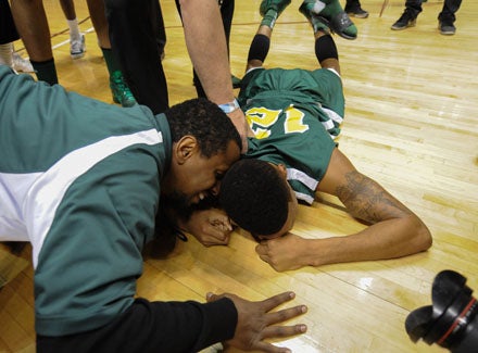 Dewayne Russell is consoled by teammates following his team's emotional 50-48 win over Amphitheater.