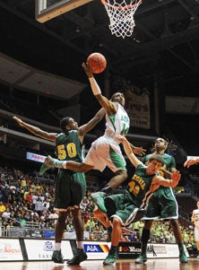 Amphitheater's Tony Lillard goes up
for two of his 12 points.