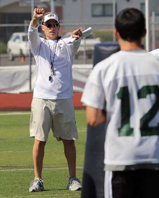 Ernie Cooper gives instruction to players during recent
spring drills at the Granite Bay football stadium.