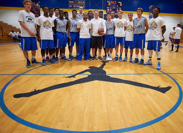 Players and coaches from the Laney High School team pose at midcourt during a recent basketball tournament. 