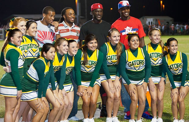 It was a night of bright lights, celebrities, pretty faces and cameras at Yulee High School Friday night. Some of the Jacksonville Jags pose for a photo with cheerleaders. 