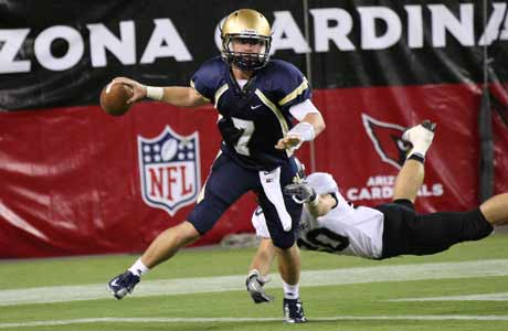 Desert Vista quarterback Matt Young eludes a diving Palo Verde defender. Young passed for 164 yards and one touchdown in his team's victory.