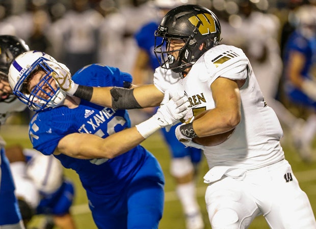 Warren Central running back Tristen Tonte stiff-arms a St. Xavier defender.