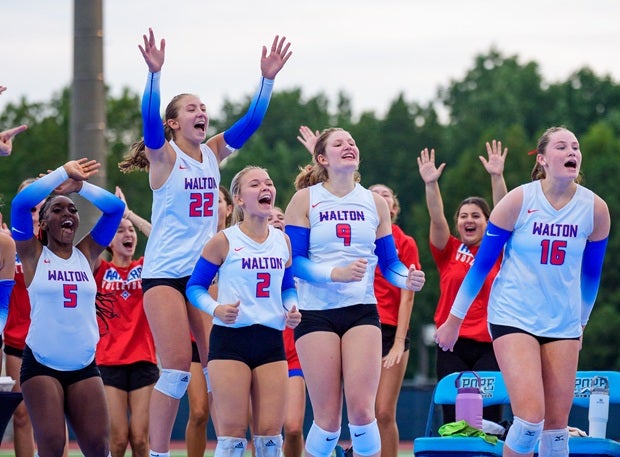Walton players cheer during their 3-1 victory over Pope on Saturday in what's thought to be the first outdoor high school volleyball match in Georgia history. (PHOTO: Luke Hamilton)