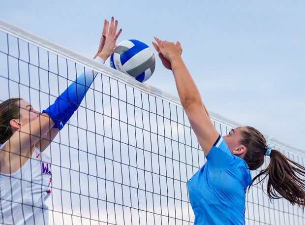 A Pope and Walton player battle at the net on Saturday. (PHOTO: Luke Hamilton)