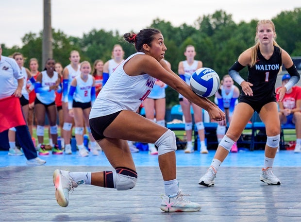 Walton's Ashlee Gomes has one of her 16 digs in the Raiders' outdoor match Saturday against crosstown rival Pope. (PHOTO: Luke Hamilton)