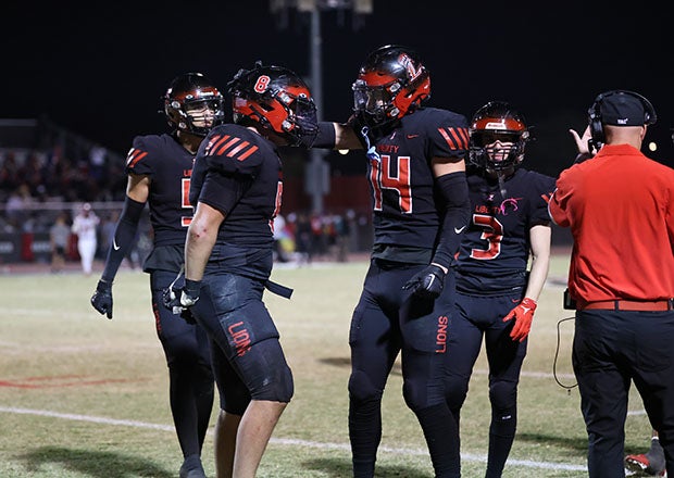 Keaton Sam (No. 8) and Braylon Gardner (14) both made big plays for Liberty against Centennial, helping the Lions win for the 20th time in their last 22 contests. (Photo: Kevin French)
