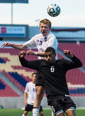 Ryan Christensen fights over a Fremont defenderfor a ball.