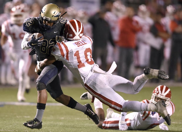 St. John Bosco receiver Josh Delgado is tackled by Mater Dei defensive back Xavier Bell.