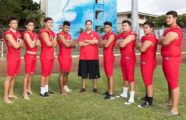 First-year head coach Makoa Freitas (center) is surrounded by several top returning players.