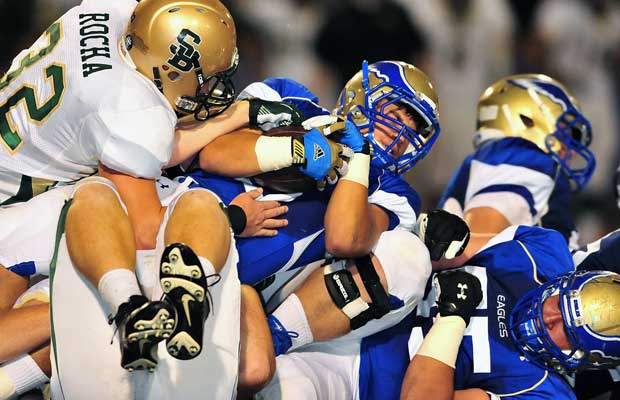 Santa Margarita's Ryan Wolpin, shown protecting the ball among a pile of players, had a 50-yard touchdown run with 1:30 remaining to seal the victory. Wolpin finished with 206 yards rushing.