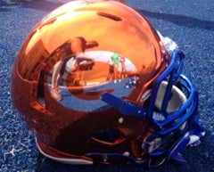 Bishop Gorman will unveil bright new
orange helmets before a packed stadium
and national television audience.