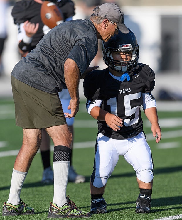 Schreiter receives instruction from a Highland assistant coach before the game.