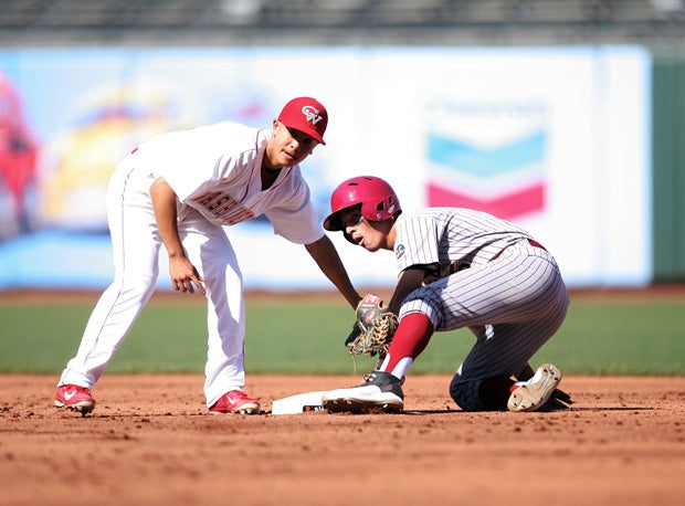 Washington shortstop Kai Moody takes a throw after Lowell's Vaughn Blue steals second base.