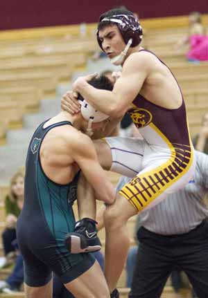 Mountain Pointe's Juan Segora (in the air) andBasha's Christian Masters (in green) battle duringthe 126-pound match at a dual meet betweenMountain Pointe and Basha.