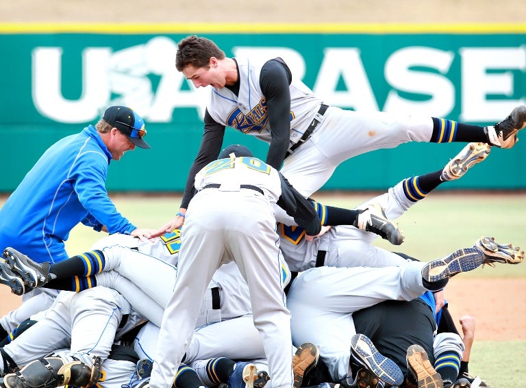 Foster Griffin jumps on the pile during The First Academy's celebration following its championship win at the NHSI.