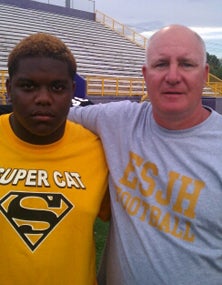 East St. John coach Phil Banko (right)
and offensive lineman Darren Davis
just help keeping push the Wildcats
through each day after Hurricane
Isaac flooded their school and destroyed
most of its football equipment.