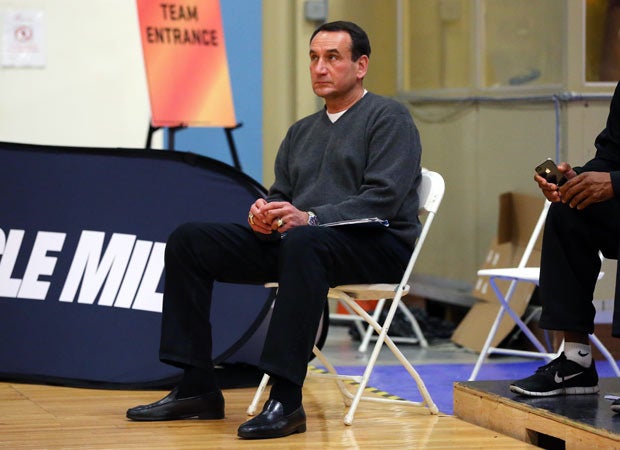 Duke coach Mike Krzyzewski sits courtside during a game played on court 1.
