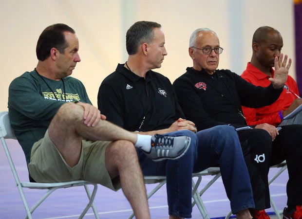 Notre Dame's Mike Brey (left) and Texas A&M's Billy Kennedy (center) listen to SMU's Larry Brown.