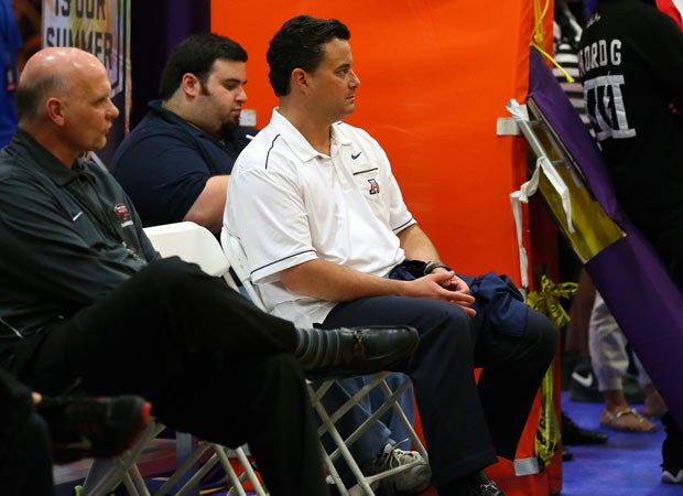 Arizona coach Sean Miller looks on from a courtside seat during a game on court 1.