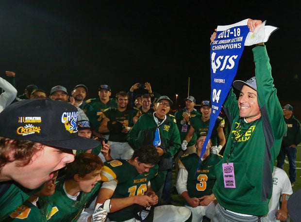 Placer coach Joey Montoya holds up banner, signaling his team's first Sac-Joaquin Section title since 1981.