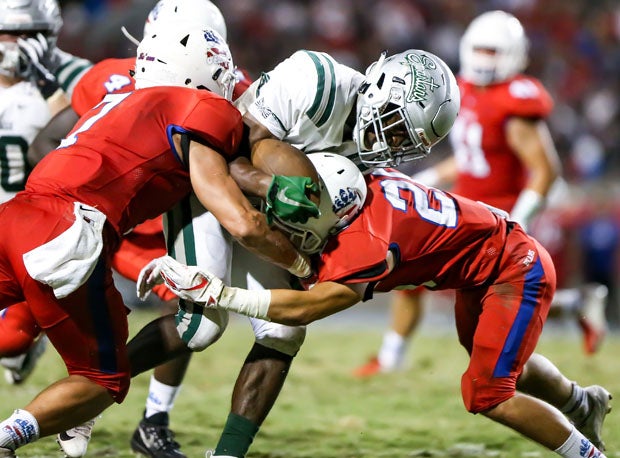 De La Salle senior Henry To'oto'o bulls his way through two would-be tacklers. 