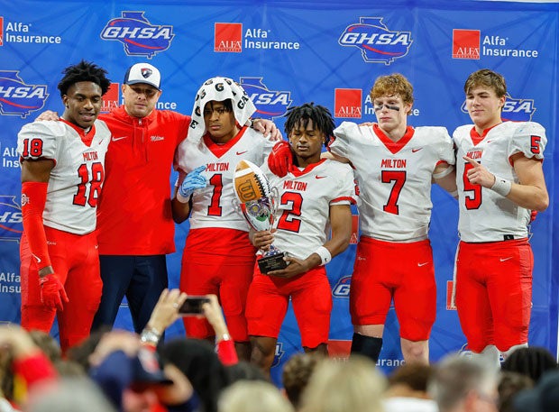 Milton players celebrate during the trophy presentation following their 31-21 win over Walton in the Georgia AAAAAAA finals on Wednesday. (Photo: Ben Ennis)