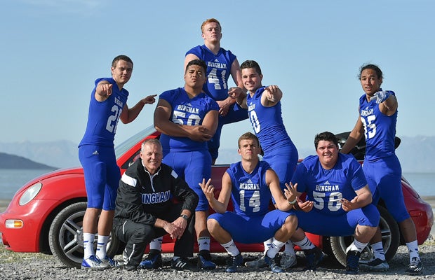 Taking time out to have a little fun during the photo shoot, the players and coach Lamourne pose in front of a Volkswagen Bug.