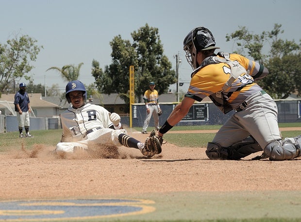 Julian Boyd of St. John Bosco slides into home plate against Edison.