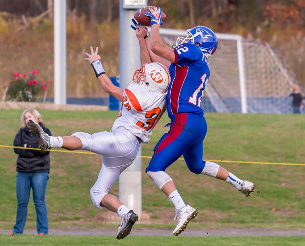 St. Paul Catholic (Conn.) receiver Daija Fitzpatrick makes a leaping catch over a Watertown defender.