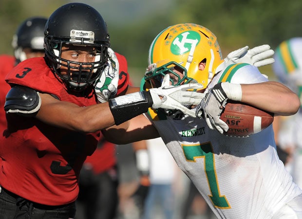 Tustin (Calif.) cornerback Jshoun Wolfe looks to tackle Kennedy receiver Joey Oretega.