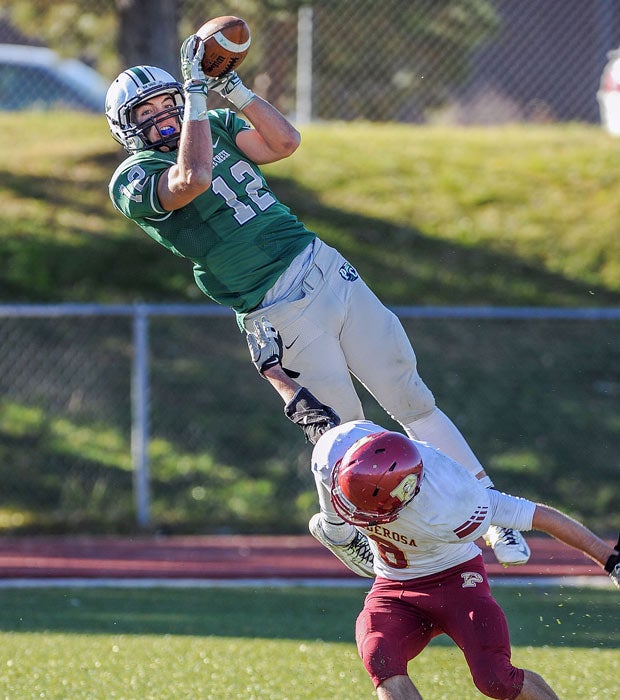 Pine Creek (Colo.) receiver JoJo Domann makes a leaping catch over a Ponderosa defender.