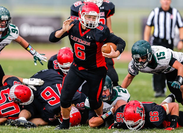 American Fork (Utah) quarterback Gavin Williams leaves a pile of players behind during a UHSAA 5A first round playoff game against Hillcrest.