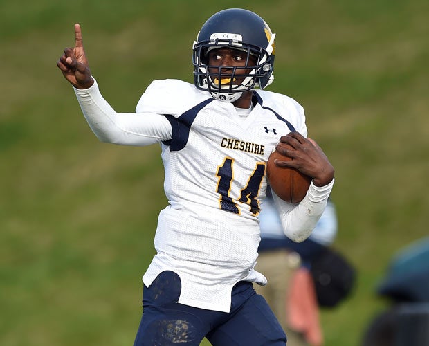 Cheshire Academy (Conn.) quarterback C.J. Lewis celebrates while scoring on a run against Canterbury.