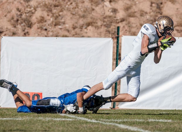 Ruidoso's (N.M.) Travis Mosher attempts to elude St. Michael's Chross Jaramillo.