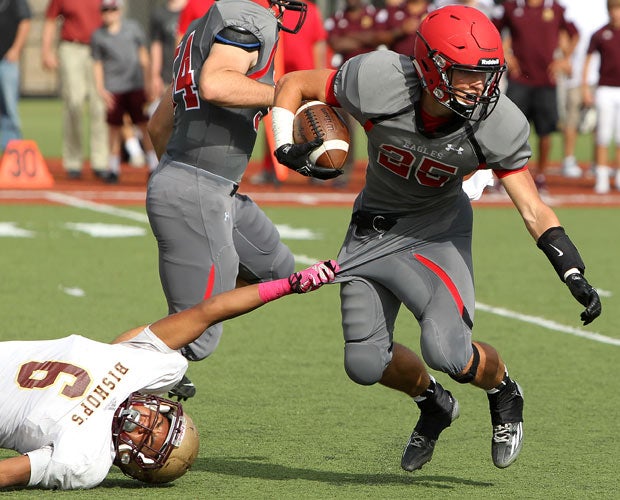Santa Fe Christian (Calif.) running back Benton Weeks attempts to elude the grasp of Bishop's linebacker Justin Woodley.