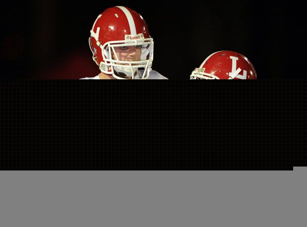 Jake Olson (58) being escorted to the field by teammate Adam Connette.