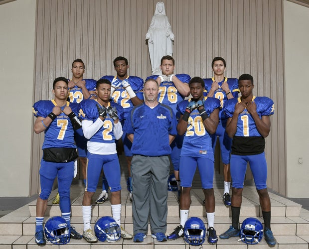 Head coach Steve Hagerty poses with several of his top players in the Grotto.