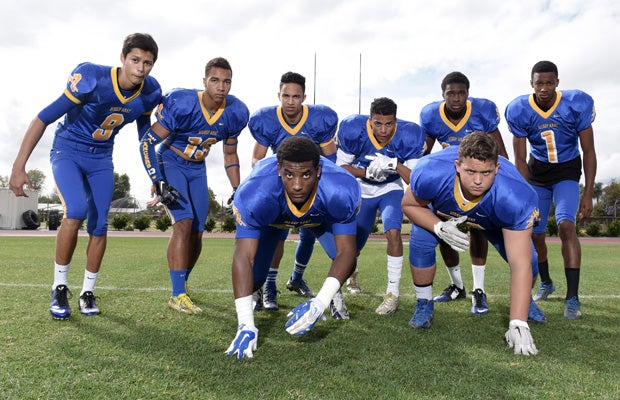 The eight players involved in the shoot pose for a group photo.