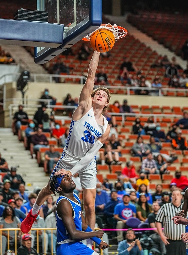 Valley Christian senior Caleb Shaw soars high for the slam against Coolidge in the Arizona 3A state finals. Shaw dropped 31 as the Trojans overcame a 14-point halftime deficit.