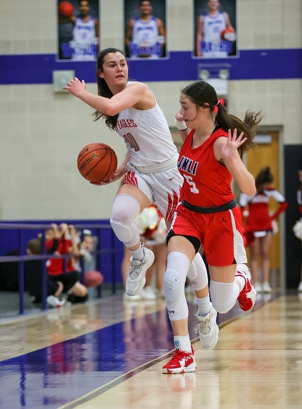 Kenna Wood of Holiday (Texas) looks to pass as she's being forced out of bounds by Jim Ned's Lexi Wishert.