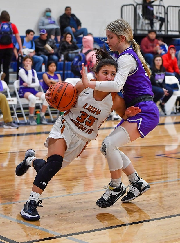 Caldwell (Texas) guard Andrea Flores drives through Florence defender Alvah Cole on her way to the basket.