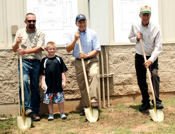 Bliss (center) helps to break ground for a new basketball arena at Allen Academy.