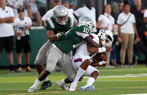 De La Salle's Henry To'oto'o (left) and Jhasi Wilson takedown Folsom quarterback Kaiden Bennett.