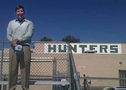 Andy Beal stands proudly in front of a legendary sign that has stood for almost four decades.