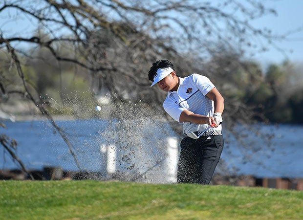 A Jesuit (Calif.) golfer hits out of a bunker during a match against St. Mary's at the Stockton Golf and Country Club. 