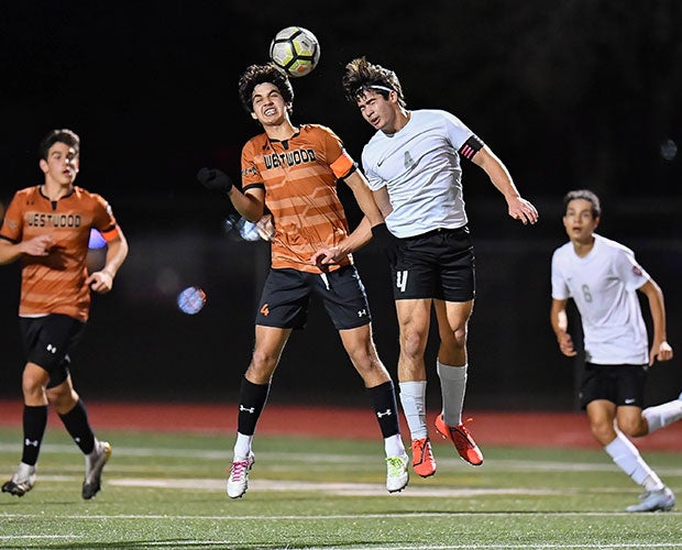 A Round Rock Westwood (Texas), left, and a Vista Ridge player leap for a header.